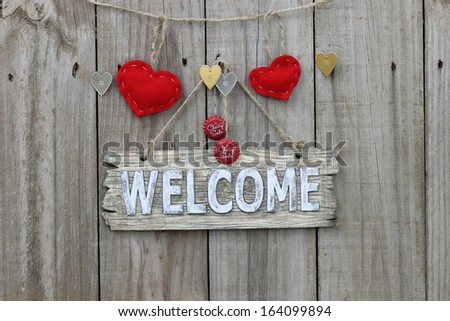 Wood welcome sign with red hearts and soda pop bottle tops