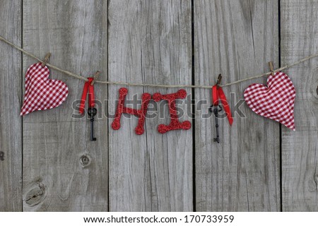 Red checkered (gingham) hearts, iron keys and HI hanging on clothesline with wood background