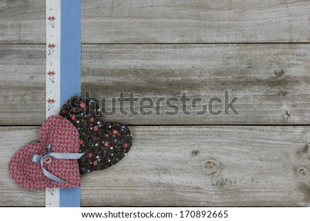 Pink and brown calico hearts and ribbon border on wood background