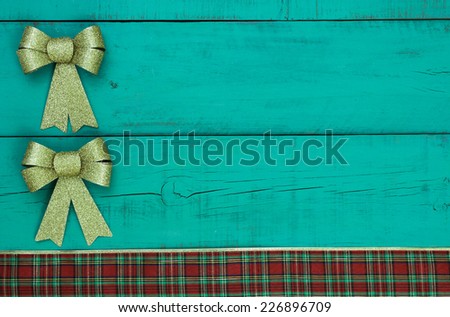 Gold Christmas bows and plaid ribbon border antique green wooden background