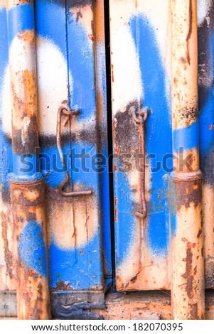 fragment of a fragment of a metal container door with graffiti. Abstract creative background