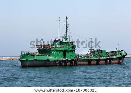 ODESSA, UKRAINE - APRIL 10: The tugboat is towing a raid on a cargo ship in the harbor seaport, April 10, 2014 Odessa, Ukraine