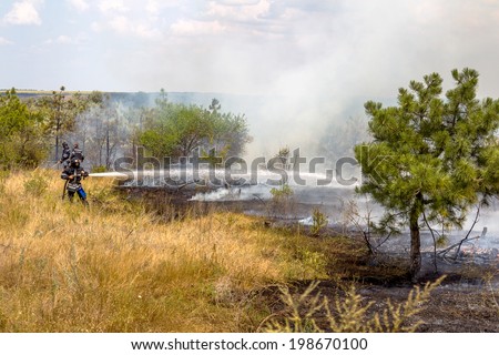 Odessa, Ukraine - August 4, 2012: Severe drought. Fires destroy forest and steppe. Firefighters in protective clothing quenched with water from hydrants pockets, August 4, 2012 in Odessa, Ukraine.