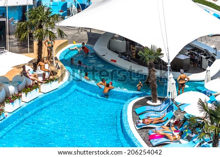 ODESSA, UKRAINE - JULY 20: Tourists on holiday in an expensive hotel Nemo popular with cascading pools and with dolphins and white whales, and dzhakusi bar July 20, 2014 Odessa, Ukraine.