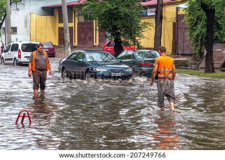 ODESSA, UKRAINE - July 24, 2014: As a result of heavy rainfall disaster flooded streets. Cars fording. Flooding. July 24, 2014 in Odessa, Ukraine