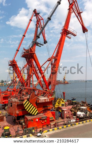 ODESSA, UKRAINE - JULY 23: large floating marine crane for loading the goods in the dry bulk cargo ships in the harbor of Odessa sea port. Mechanisms and buckets, July 23, 2014 Odessa, Ukraine
