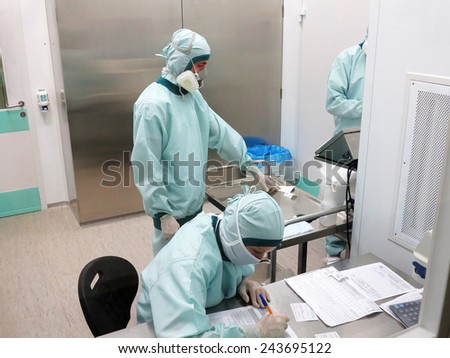 ODESSA - JULY 11: The modern factory production of pharmaceutical technologies. Pharmaceutical industry.  Pharmaceutical workers at work in hazardous chemical bokse 11 July 2013 in Odessa, Ukraine