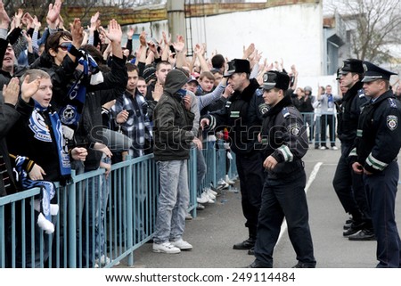 Odessa, Ukraine - November 14, 2010: Ultras emotional football fans during the game for his club Chernomorets rioted with police, broken rostrum, fights, fireworks on the playing field