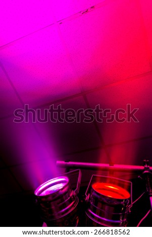 Spotlight stage light in a cloud of smoke. Colored spots of light and smoke on the ceiling of the theater during a concert party nightclub