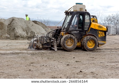 ODESSA, UKRAINE - April 5, 2015: Brigade road maintenance within the framework of urban repairs after winter frosts that destroyed coating. Laying of paving slabs in the square