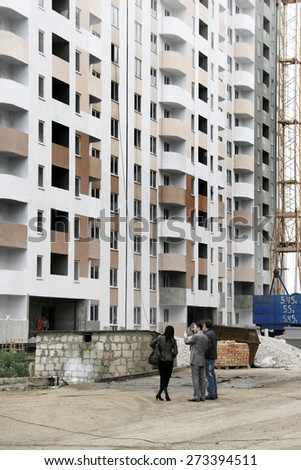Odessa, Ukraine - November 3, 2008: Construction site of a high-rise apartment building. Delivery of construction. Finishing work. Buyers, tenants visiting the home. Apartments for sale. facade work