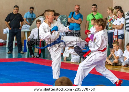 ODESSA, UKRAINE - June 7, 2015: Karate Tournament Streda children and adolescents. The battle on mat karatekas. Children, boys and girls making their first steps in learning the art of martial arts