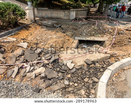 Odessa, Ukraine, June 21, 2015 - During the construction of the road is the reconstruction of sewage facilities. Dismantle the old drain wells, changing outdated sewage equipment