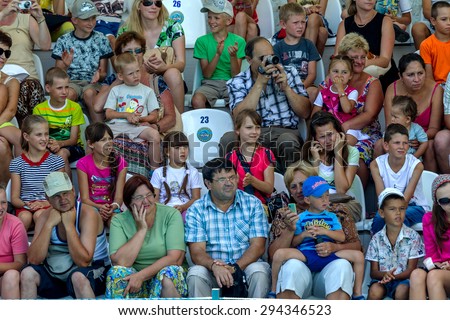 Odessa, Ukraine - July 10, 2013: Ecstatic happy spectators of all ages delightedly watching vivid picture dresirovannyh dolphins. Show at the dolphinarium