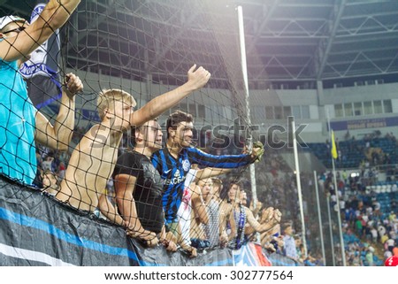 ODESSA, UKRAINE - August 2, 2015: Football fans and spectators in the stands of the stadium emotionally support their team during the game FC Dynamo Kyiv - Chernomorets Odessa. Major League.