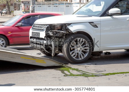 Odessa, Ukraine - May 3, 2015: A car accident in the city center. expensive car was loaded onto a tow truck after a car accident.