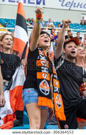 ODESSA, UKRAINE - 14 August, 2015: Football fans and spectators in  stands of the stadium emotionally support their team during  game of FC Shakhtar (Donetsk) - Dnipro (Dnipropetrovsk).  Ukrainian Cup