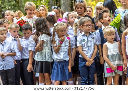 Odessa, Ukraine - September 1, 2015: primary school children with teachers and parents on the first day of the school year. Feast Day of Knowledge. Classes start the new school year.