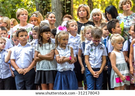 Odessa, Ukraine - September 1, 2015: primary school children with teachers and parents on the first day of the school year. Feast Day of Knowledge. Classes start the new school year.