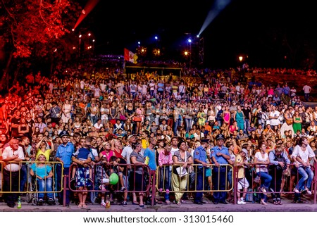 Odessa, Ukraine - September 2, 2015: The audience at a concert during the creative light and music show fashionable orchestra. Night scene, audience emotionally watching, standing outside on stairs