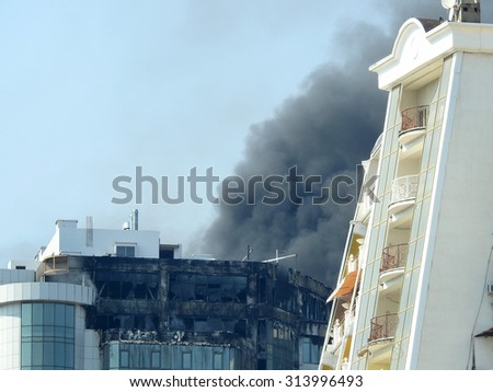 ODESSA, UKRAINE - 30 August 2015: The new construction skyscraper on fire. Violation of safety when building house. Extinguishing system is not working. Large losses of construction company.