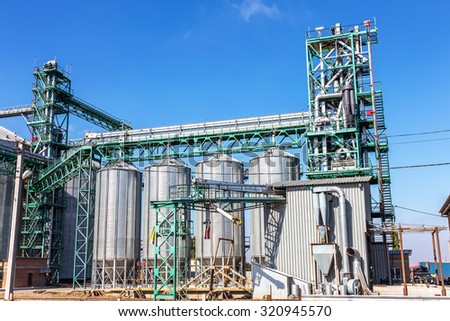 Odessa, Ukraine - September 26, 2015: Modern granary. Storage bins wheat and drying. Tanks for the storage of grain and metal girders of the auxiliary industrial equipment