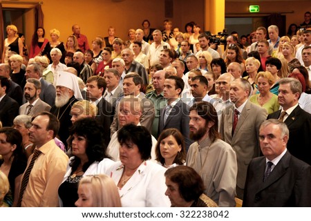 Odessa, Ukraine - June 25, 2010: Zritelnny Hall Concert Hall. Spectators before the solemn meeting and a concert. Spectators stot during the anthem of the state. The audience in the hall.