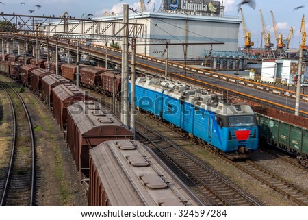 Odessa, Ukraine - 6 October 2015: Freight train on the branch railway terminal. Rail transportation. Freight. A train carrying wood, timber, lead ingots, billets metal. A train in motion