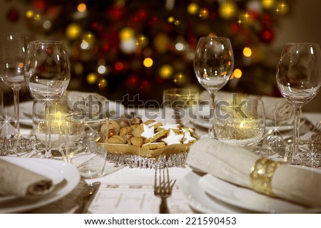 Festive Table With Christmas Tree In The Background Stock Photo ...
