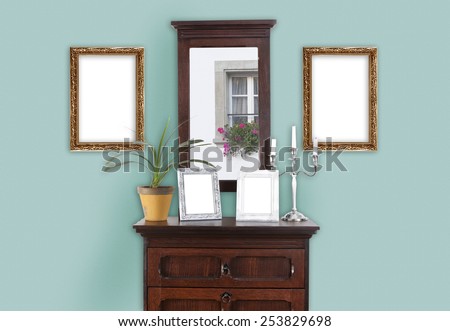 on a wall with a dresser, several paintings frame