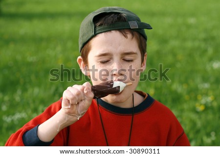 boy eating ice cream on a stick, wolf down
