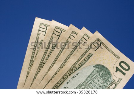 Ten dollar bills with the words \'we trust\' clearly shown.