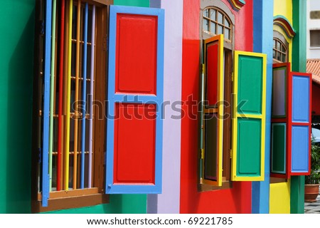 Colorful windows and detail on a colonial house in Singapore.  The picture is full of color.