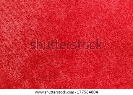 a pinkish red background of warm, cozy micro-fleece blanket fabric