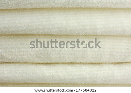 a stack of soft, white, micro fleece blankets or towels looks luxurious