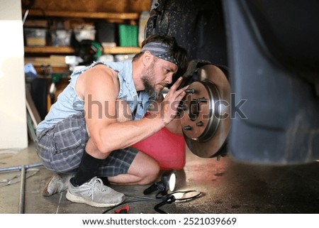 Similar – Image, Stock Photo Bearded mechanic repairing wheel of bicycle