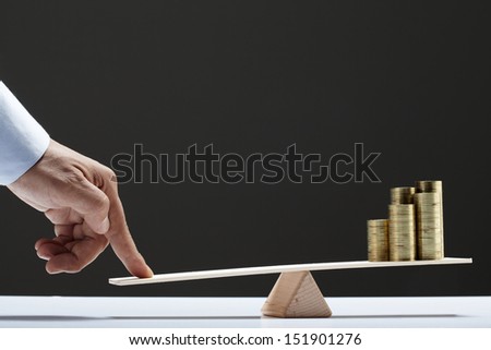 coins balance on wooden board