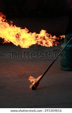 Liquid propane gas leak with someone holding fire stick