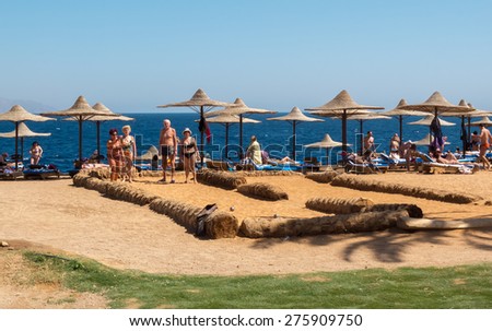 Sharm el-Sheikh, Egypt - February 25, 2013: Elderly tourists on the beach in Sharm el-Sheikh to play bowling on the beach. Seniors on vacation in the resorts of the Red Sea in Egypt in February.