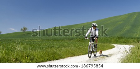 man with bike walk with dog