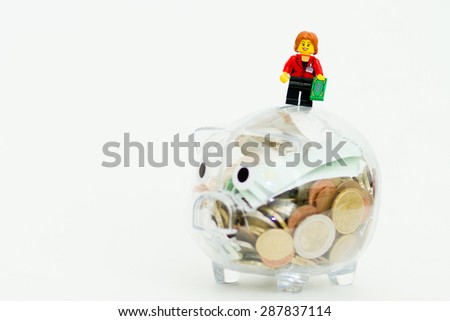 Orvieto, Italy - June 16th 2015: Lego minifigure on piggy bank. Save a money. Lego is a popular line of construction toys manufactured by the Lego Group