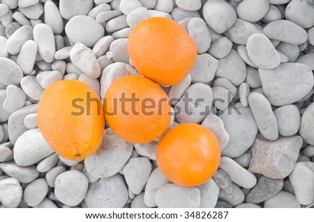 four oranges on the stones