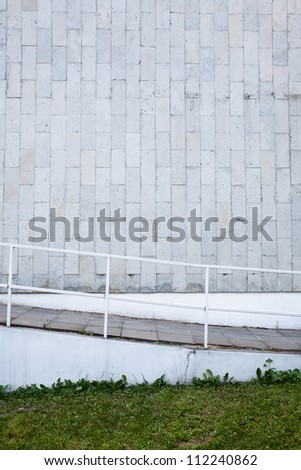 Tiled wall with a blank gray bricks  and stairs