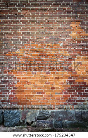 Red brick wall background with stone basement