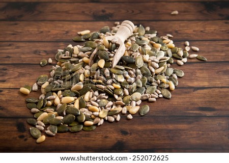 mixed seeds over wooden background
