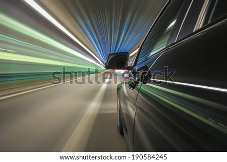 driving trough city tunnel, bulb exposure, rigged camera on side of a german black car during night, special effects photography