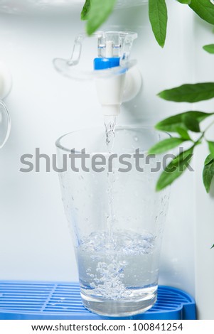 pouring a glass of water from dispenser