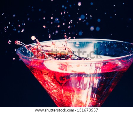 red splashing cocktail on black