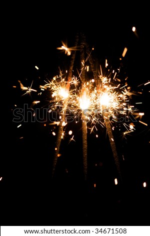 yellow sparkler with fire particles
