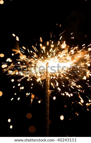 yellow sparkler with fire particles